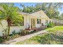 Side view showcasing the home's architectural details and surrounding landscaping at 4805 E Regnas Ave, Tampa, FL 33617