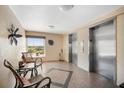 Hallway with seating in a condo building and elevators at 5130 Brittany S Dr # 604, St Petersburg, FL 33715