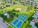Aerial view of neighborhood featuring tennis courts, a baseball field, playground, and green space at 5340 Denver Ne St, St Petersburg, FL 33703
