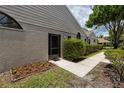 Exterior of home with mature landscaping including green hedges and flower beds at 5524 Salem Square N Dr, Palm Harbor, FL 34685