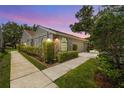 Well-maintained home with walkway and attached garage under a beautiful sunset at 5524 Salem Square N Dr, Palm Harbor, FL 34685