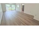 A well-lit living room with modern flooring and access to the backyard at 6206 Dewdrop Way # 0, Temple Terrace, FL 33617