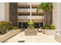 The exterior entrance is landscaped with palm trees and seasonal color at 7050 Sunset S Dr # 1401, South Pasadena, FL 33707