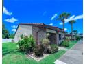 Attractive exterior featuring stucco and brick facade, tile roof and green lawn at 7360 Ulmerton Rd # 16A, Largo, FL 33771
