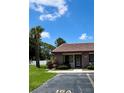 Charming villa entrance with front parking and lovely, tropical landscaping at 7360 Ulmerton Rd # 16A, Largo, FL 33771