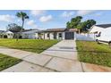 Beautiful single-story home with a well-maintained lawn and a cozy, inviting front porch at 8418 Westridge Dr, Tampa, FL 33615