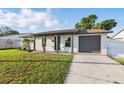 Lovely single-story home featuring a well-kept lawn, a welcoming front porch, and a one car garage at 8418 Westridge Dr, Tampa, FL 33615
