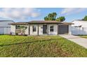 Single-story home boasting a well-kept lawn, front porch, and attached one car garage at 8418 Westridge Dr, Tampa, FL 33615
