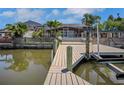Private dock overlooking tranquil water with great views of the screened-in pool area at 8711 Thornwood Ln, Tampa, FL 33615