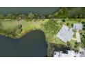Expansive waterfront lot with lush greenery and mature trees surrounding the property at 8927 Key West Island Way, Riverview, FL 33578