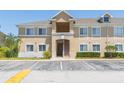 A tan building with a covered entrance and ample parking spaces at 9524 Newdale Way # 101, Riverview, FL 33578