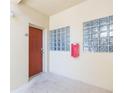 Hallway with a brown door and glass block windows at 9524 Newdale Way # 101, Riverview, FL 33578