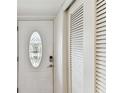 Entryway featuring a decorative door with oval glass insert and adjacent closet doors at 1 Boca Ciega Point Blvd # 310, St Petersburg, FL 33708