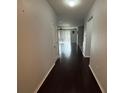 Hallway with wood floors leading into the spacious living area at 10766 Standing Stone Dr, Wimauma, FL 33598
