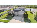 A lovely single Gathering home that features 2 garage spaces with a view of the pond and surrounding community at 12745 Moorish Pl, Spring Hill, FL 34610