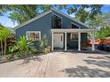 Inviting home exterior with a covered porch and well-manicured landscaping in a lovely neighborhood at 1304 Withlacoochee St, Safety Harbor, FL 34695