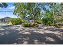 Charming home featuring lush landscaping, inviting entryway, and a driveway with ample parking at 1304 Withlacoochee St, Safety Harbor, FL 34695