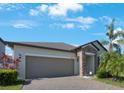 Charming one-story home featuring a two-car garage, stone accents, and well-maintained landscaping at 13213 Haystack Ct, Riverview, FL 33579