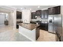 Modern kitchen with stainless steel appliances, granite countertops, a kitchen island, and tile flooring at 13213 Haystack Ct, Riverview, FL 33579