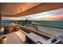Spacious balcony with comfortable seating offers stunning ocean views at sunset at 1340 Gulf Blvd # 16A, Clearwater Beach, FL 33767