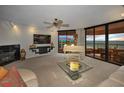 Bright living room with fireplace, floor to ceiling windows, ocean view, white piano and comfortable seating at 1340 Gulf Blvd # 16A, Clearwater Beach, FL 33767