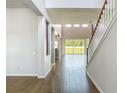 Bright foyer showcasing wood-look tile flooring, staircase, and an open floor plan at 14137 Wake Robin Dr, Brooksville, FL 34604