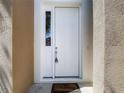 Close-up of a white front door with a side window panel and a 'Welcome' mat at 14137 Wake Robin Dr, Brooksville, FL 34604