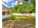 Spacious backyard with a well-maintained lawn and privacy fence, perfect for outdoor activities at 14273 Nugent Circle, Spring Hill, FL 34609