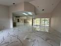 Expansive living room featuring elegant marble floors, lots of natural light, and an open floor plan at 14273 Nugent Circle, Spring Hill, FL 34609