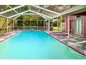 Relaxing screened-in pool area with a hot tub, offering the perfect space for outdoor fun at 14273 Nugent Circle, Spring Hill, FL 34609