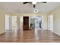 Open-concept living room featuring newer vinyl plank flooring, plenty of natural light, and views into the kitchen at 1810 77Th N Ave, St Petersburg, FL 33702