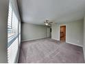 Neutral bedroom featuring an ensuite bathroom, closet and ceiling fan at 1881 Colding Dr, Ruskin, FL 33570