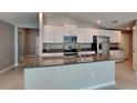 Modern kitchen with granite countertops, stainless steel appliances, and white cabinetry at 1881 Colding Dr, Ruskin, FL 33570