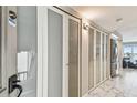 Bright condo hallway with marble floors, ample closet space, and modern lighting at 19010 Gulf Blvd # 203, Indian Shores, FL 33785