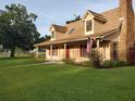 Beautiful home with dormer windows, covered porch, and an American flag at 2615 Southern Oaks Pl, Plant City, FL 33566