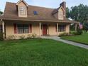 Charming two-story home featuring a cozy front porch and well-maintained landscaping at 2615 Southern Oaks Pl, Plant City, FL 33566