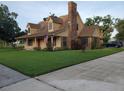 Inviting two-story home showcasing a brick chimney and attractive landscaping at 2615 Southern Oaks Pl, Plant City, FL 33566