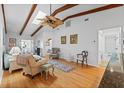 Bright living room featuring hardwood floors, a ceiling fan, skylights and beamed vaulted ceiling at 2665 Sequoia Ter # 306, Palm Harbor, FL 34683
