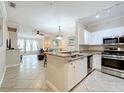 Bright kitchen featuring granite countertops, stainless steel appliances, and a seamless flow into the living area at 2724 Via Murano # 615, Clearwater, FL 33764
