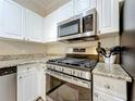 Well-equipped kitchen with stainless steel appliances, granite countertops, and white cabinets at 2724 Via Murano # 615, Clearwater, FL 33764