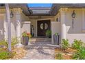Elegant front entrance with a double door, decorative columns, and brick paved walkway at 2817 Seabreeze S Dr, Gulfport, FL 33707
