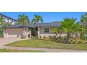 Charming single-story home featuring lush landscaping and a well-manicured lawn at 2817 Seabreeze S Dr, Gulfport, FL 33707