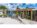 This home features a unique trellis and artistic front yard with rock features and a charming display at 2912 Case Ave, Bradenton, FL 34207