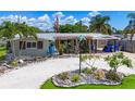 Charming home featuring a landscaped front yard, unique rock features, and a covered carport at 2912 Case Ave, Bradenton, FL 34207