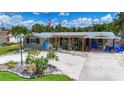 Charming home featuring a landscaped front yard, unique rock features, and a covered carport at 2912 Case Ave, Bradenton, FL 34207