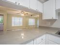 The kitchen has a breakfast bar with gray countertops and white cabinets at 3002 W Cleveland St # C3, Tampa, FL 33609