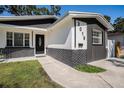 Charming home features a modern black and white exterior with a well-manicured lawn at 3019 Park N St, St Petersburg, FL 33710