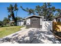 Single-story home showcasing well-manicured lawn, sidewalk, and black brick accent walls at 3019 Park N St, St Petersburg, FL 33710