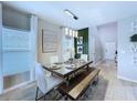 Bright dining room with modern chandelier, stylish table setting, and large windows with natural light at 34056 Scarlet Sage Ct, Wesley Chapel, FL 33545