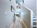 Elegant hallway features hardwood floors, stylish decor, and a view into the dining and living areas at 34056 Scarlet Sage Ct, Wesley Chapel, FL 33545